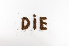 Close-up of the word die made of tobacco on a white background